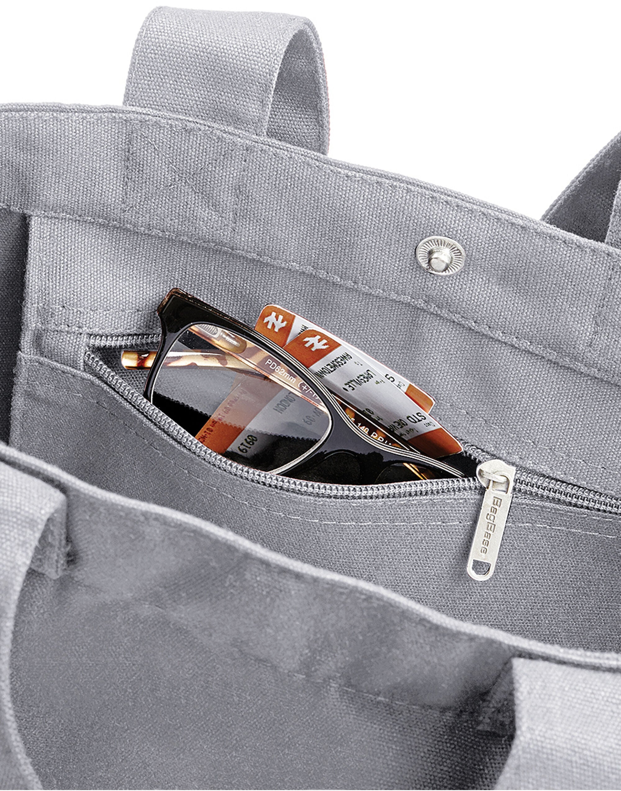 Close-up of the durable canvas material and dual carry handles on the Bagbase Canvas Day Bag.