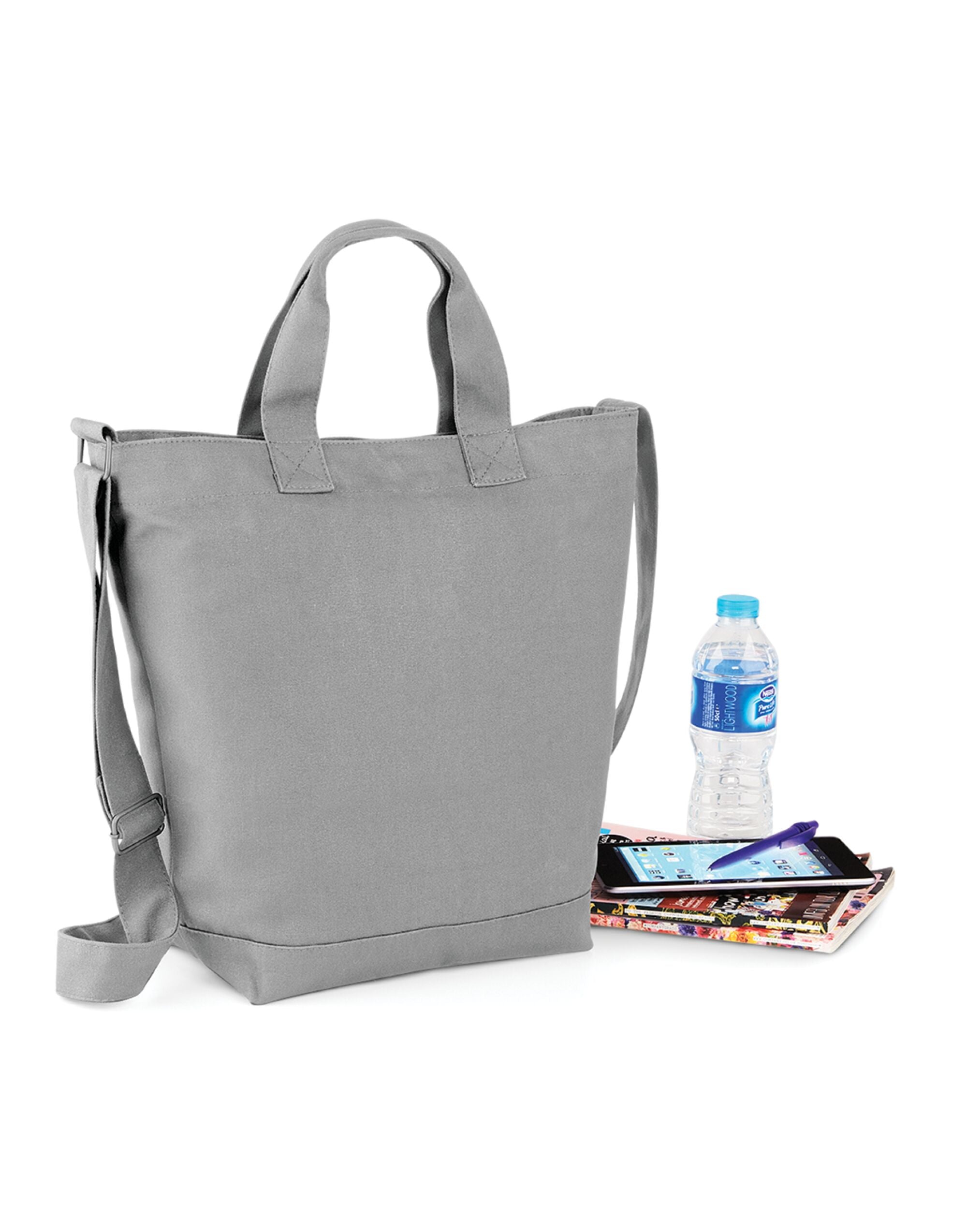 Side profile of the navy Bagbase Canvas Day Bag, illustrating its practical size and shape.