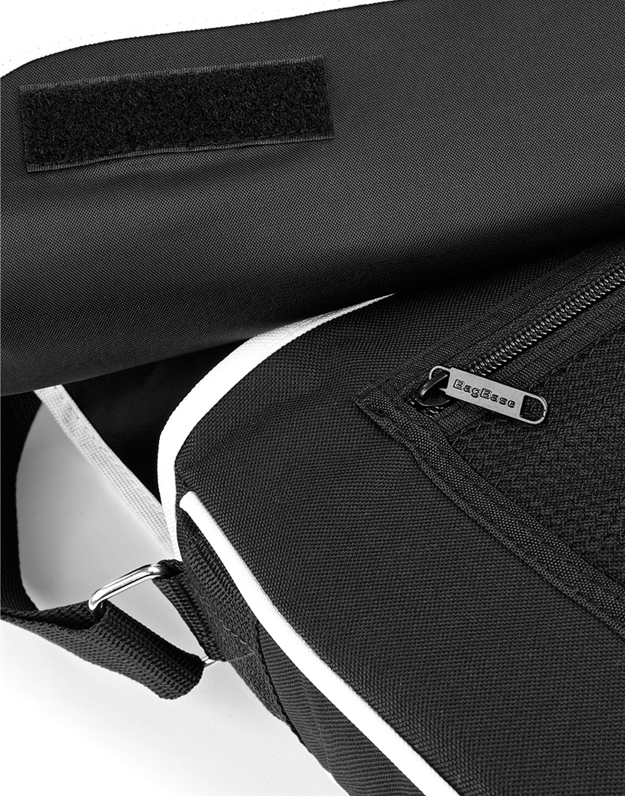 Side profile of the black Bagbase Retro Messenger, illustrating its capacity for books and a small laptop.