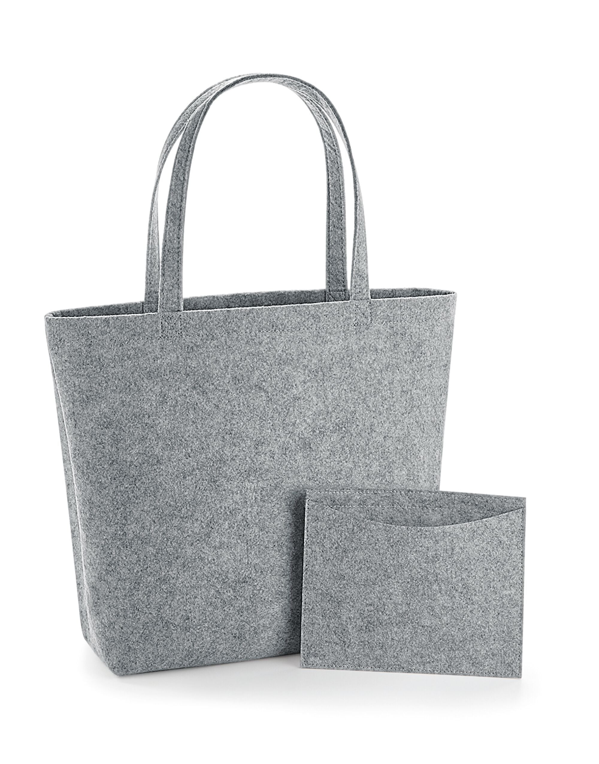 A person carrying the light grey marl Bagbase Felt Shopper to demonstrate its size and stylish look.
