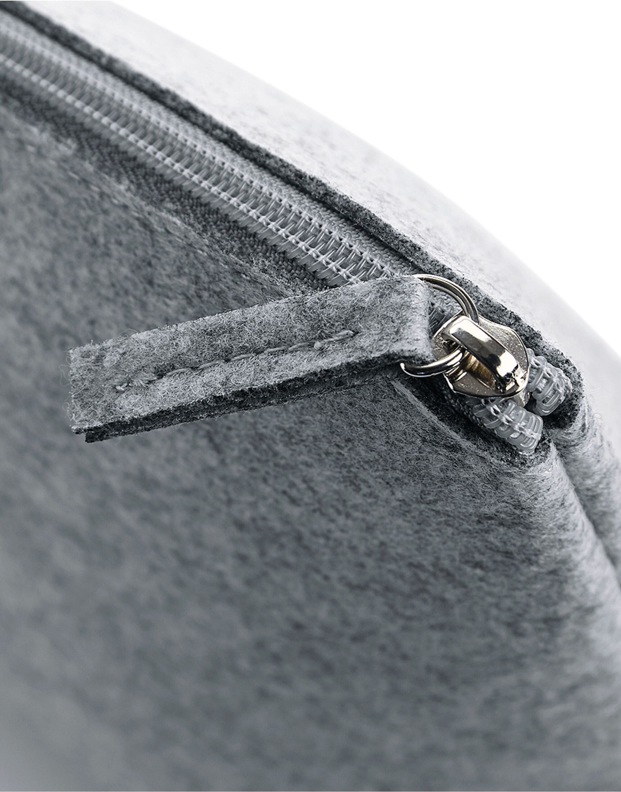 Detail shot of the zipper pull on the Bagbase Felt Accessory Bag.