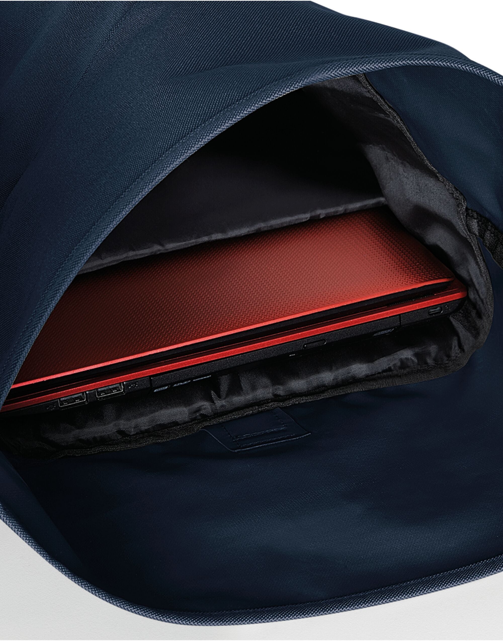 The expandable Bagbase Roll-Top Backpack shown partially unrolled to showcase its flexible storage capacity.