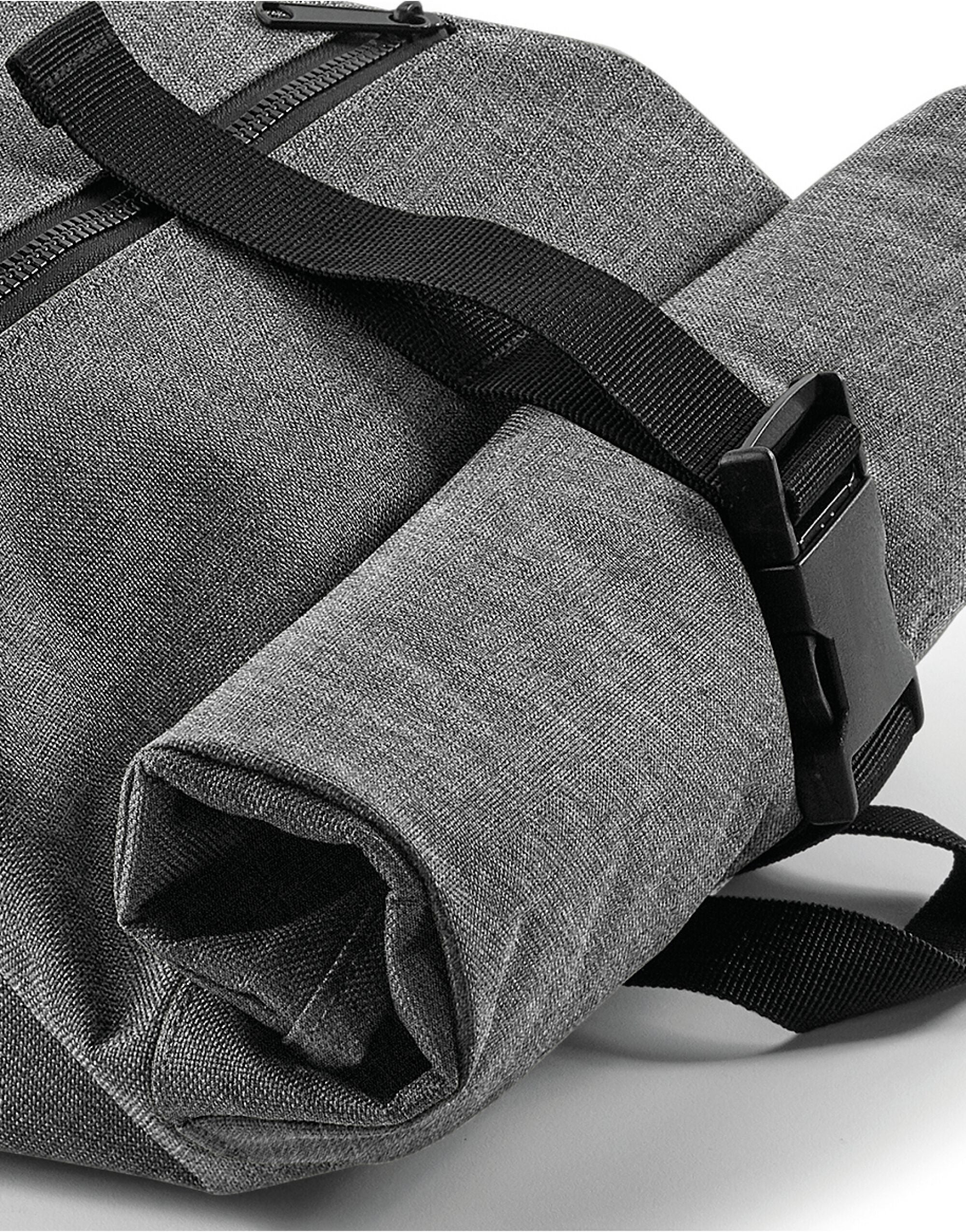 Angled view showcasing the textured material of the graphite grey Bagbase Roll-Top Backpack.