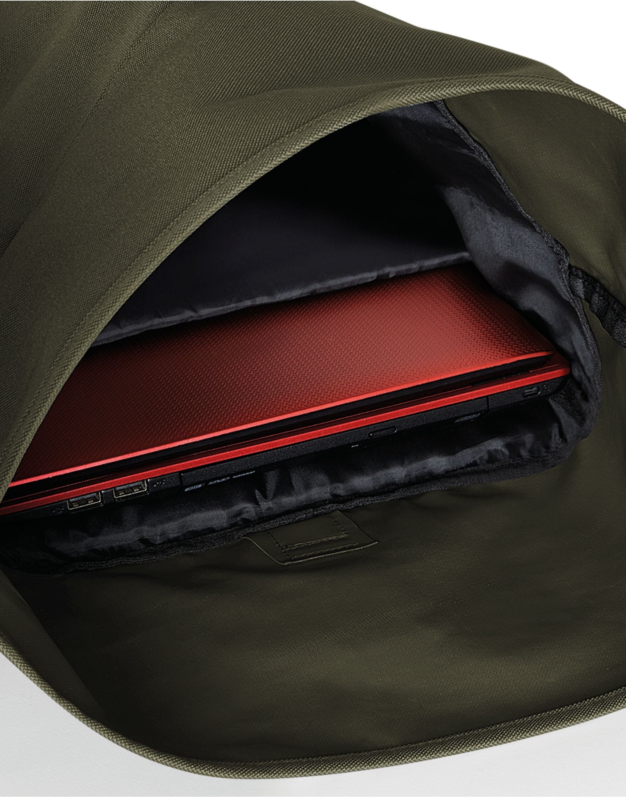 Three-quarter profile of the heather grey Bagbase Roll-Top Backpack, highlighting its modern silhouette.