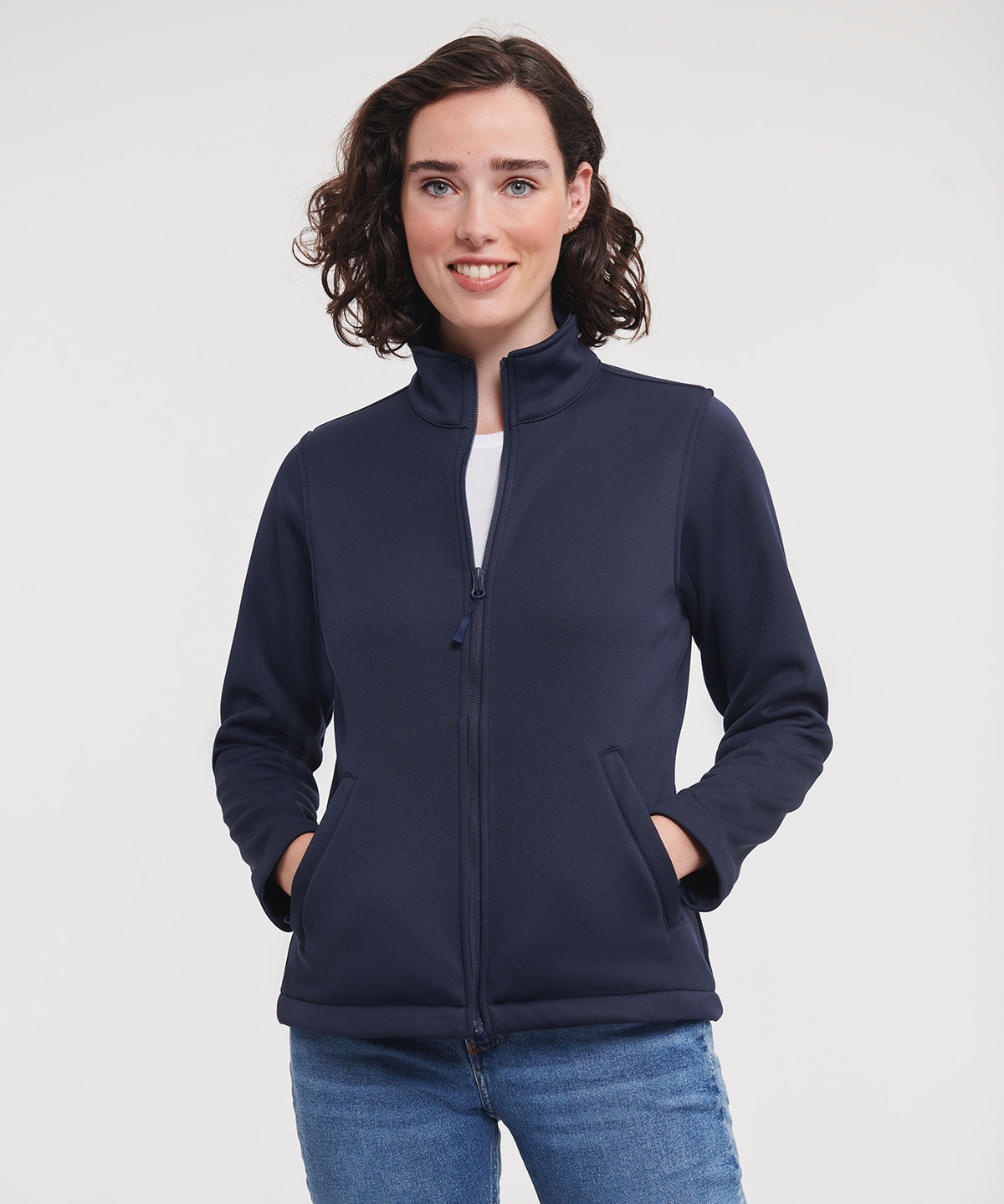 Lady is wearing Russell Ladies Smart Softshell Jacket