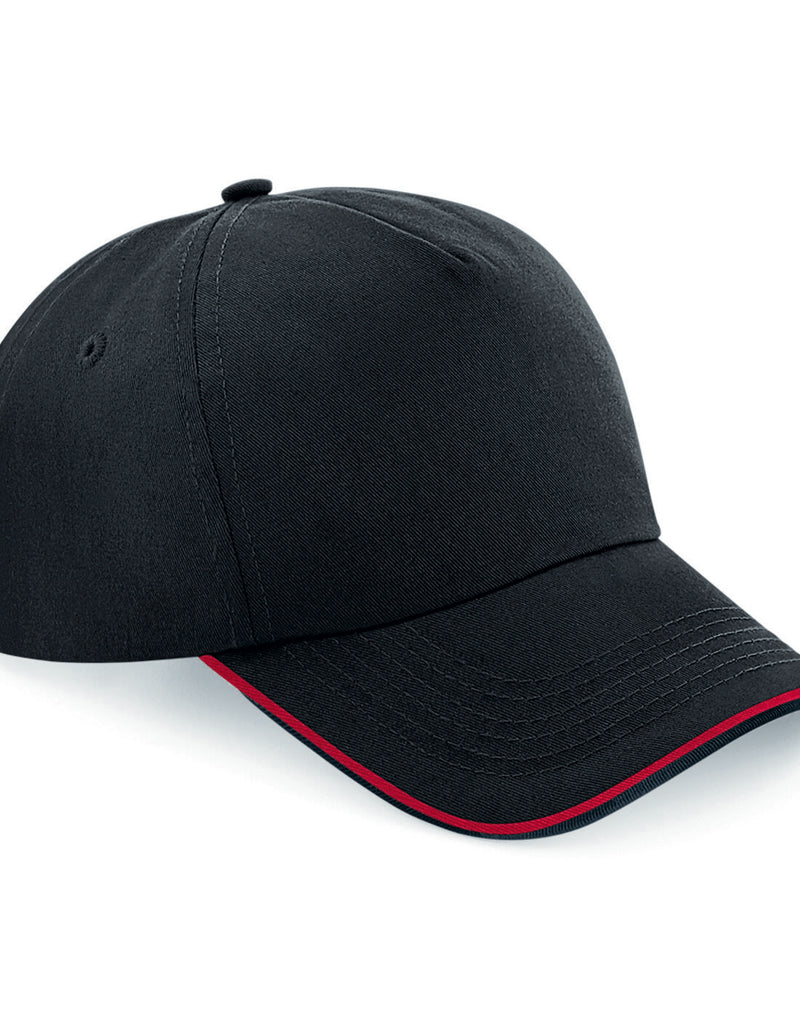 Beechfield B25C youth snapback trucker cap in black with classic red mesh.