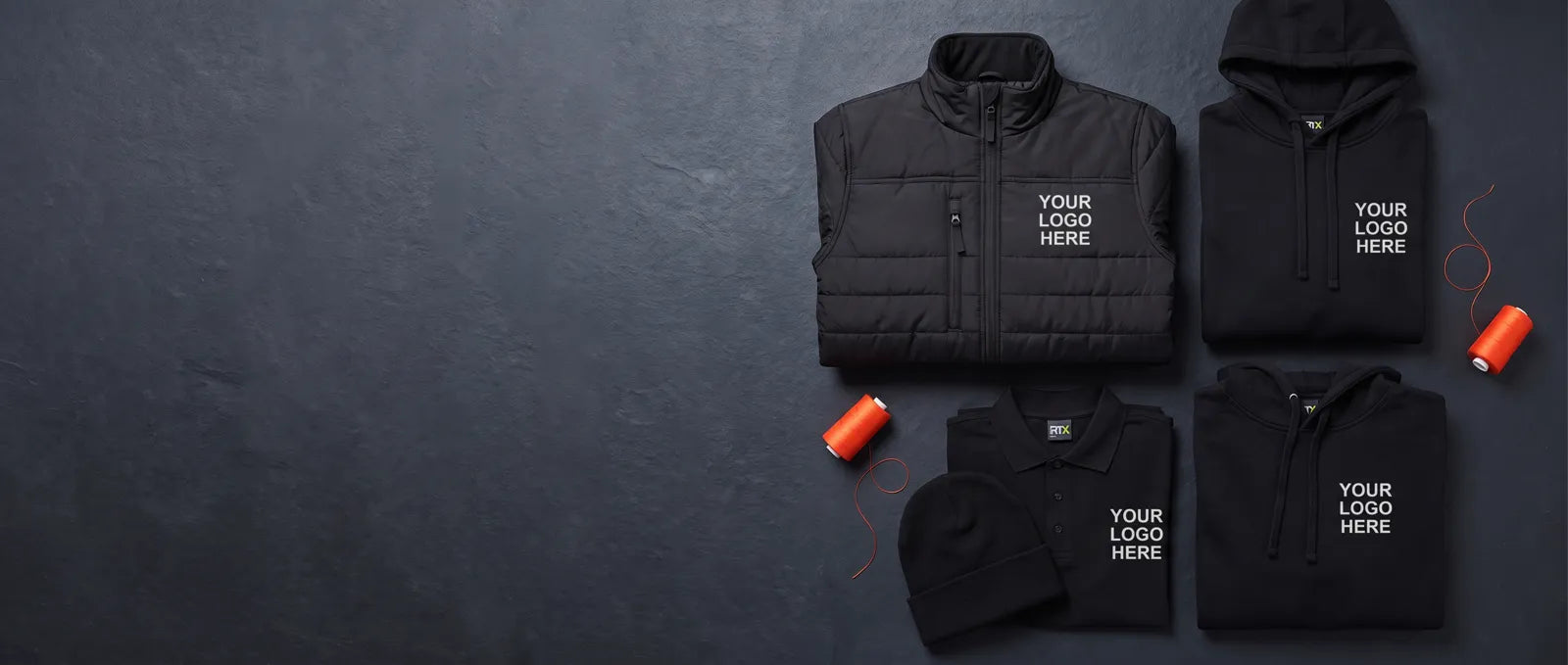 Black branded workwear kit laid flat, each piece embroidered with your logo